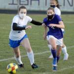 Olympics Claire Caldwell, left, races for the ball with Sequims Taryn Johnson in the first half on Tuesday at Sequim High School. Behind is Johnsons teammate, Alliyah Weber. (Keith Thorpe/Peninsula Daily News)