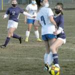 Sequims Alliyah Webber, right, and Olympics Kaleia Sandbeck square off on the ball as Sequims Natalya James, left, and Olympics Alexis Valenzuela look on during Tuesday nights match in Sequim. (Keith Thorpe/Peninsula Daily News)
