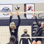 Napavine's Grace Gall (4) attempts to block a hit by Forks' Katie Wood on Wednesday evening in Forks, where the Tigers defeated the Spartans 3-0 in the Class 2B Southwest District Volleyball Tournament. (Lonnie Archibald/for Peninsula Daily News)