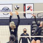 Napavines Grace Gall (4) attempts to block a hit by Forks Katie Wood on Wednesday evening in Forks, where the Tigers defeated the Spartans 3-0 in the Class 2B Southwest District Volleyball Tournament. (Lonnie Archibald/for Peninsula Daily News)
