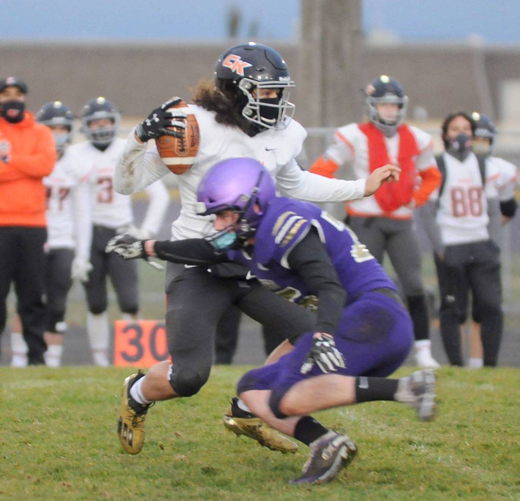 Sequims Austin Newton attempts to corral Central Kitsap quarterback Kalai Pasai during the Wolves 38-22 win over the Cougars.
Michael Dashiell/Olympic Peninsula News Group