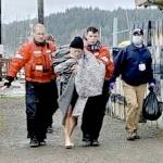 Members from Coast Guard Station Quillayute River help a man to an awaiting ambulance after the vessel he was in sank on Saturday 5 miles off the coast of La Push. None of the three men were wearing lifejackets. (U.S. Coast Guard photo by Station Quillayute River)