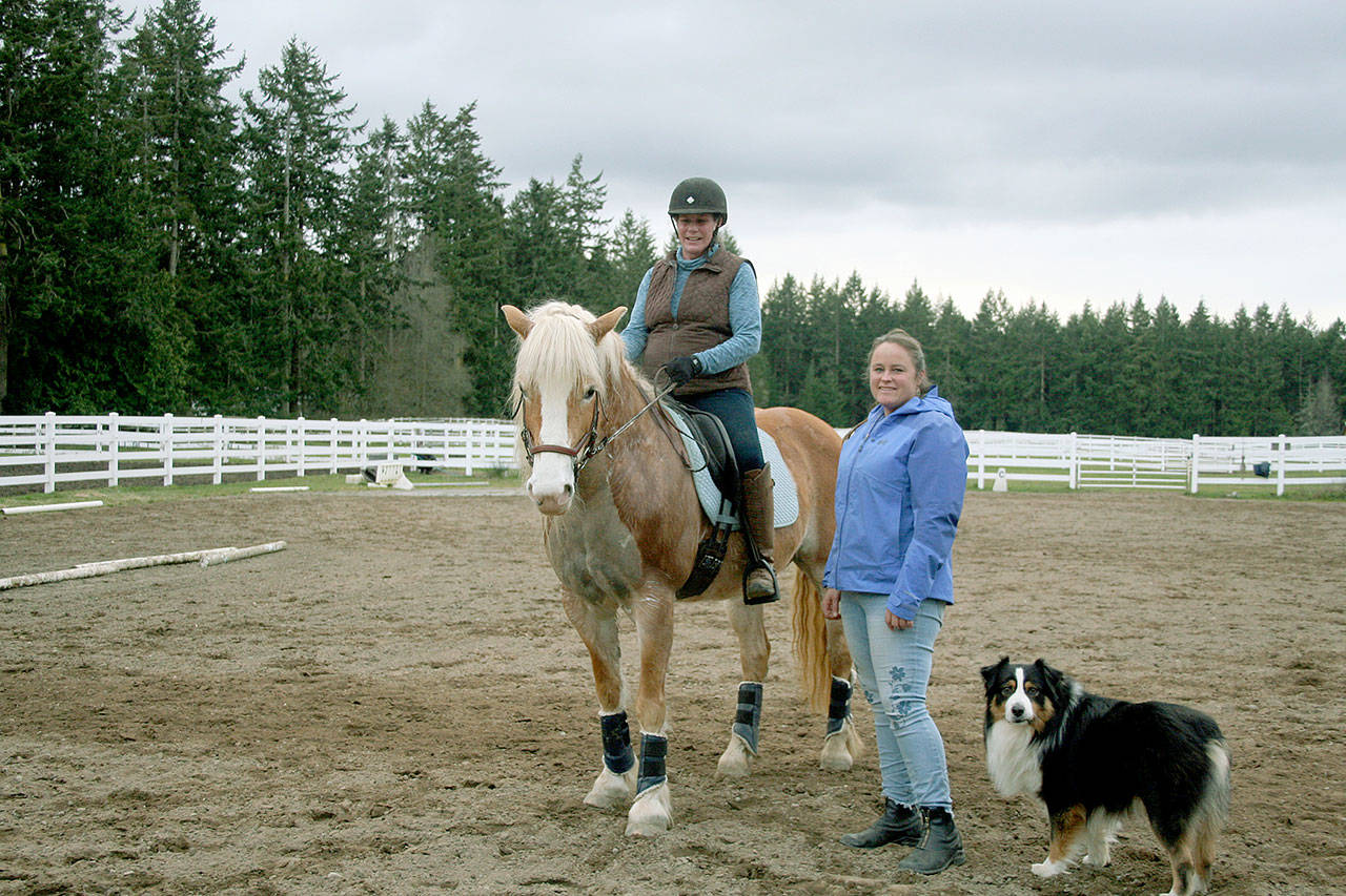 After retiring in June last year, Amy Greenbaum, on BelClaire, became a working student  someone who does barn chores  for Fédération Équestre Internationale competitor, trainer and instructor Becky Cushman with Casey at Paradigm Sporthorse in Port Townsend. (Karen Griffiths/for Peninsula Daily News)