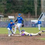 Sequims Ryan Porter slides safely into second under the glove of East Jeffersons Hunter Cerna during a rainy Wednesday afternoon game played in Chimacum. Poised to back up the play is Marcus Ritch (3). (Steve Mullensky/for Peninsula Daily News)