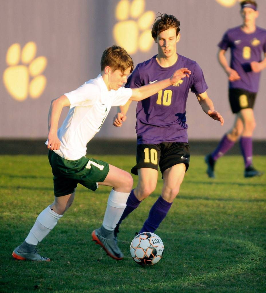 Port Angeles Kaleb Gagnon, left, looks to advance the ball in Sequim territory as the Wolves Eli Gish defends in a March 25 match. Gish scored in the first half  his sixth goal in the seasons first two games  as the Wolves shut out the Riders, 2-0. Michael Dashiell/Olympic Peninsula News Group