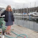 Port Angeles Yacht Club Commodore Erika Hansen-Dahlin stands on the Port Angeles Boat Haven fuel dock, a feature destined to be replaced as part of $2.1 million in improvements approved by the Port of Port Angeles. (Keith Thorpe/Peninsula Daily News)