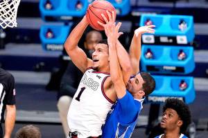 Gonzaga guard Jalen Suggs (1) drives on Creighton guard Marcus Zegarowski (11) in the second half of a Sweet 16 game in the NCAA men's college basketball tournament at Hinkle Fieldhouse in Indianapolis, Sunday, March 28, 2021. (AP Photo/Michael Conroy)