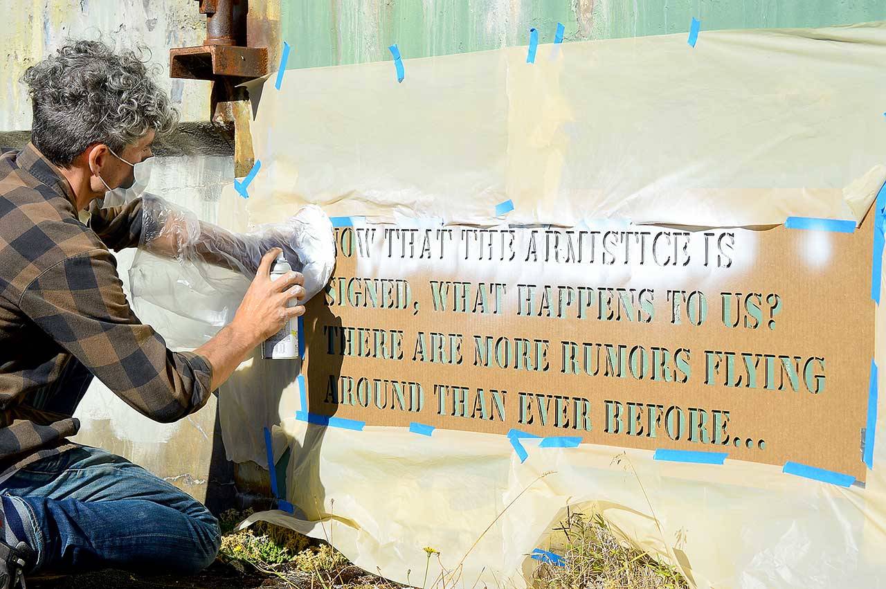 Aaron Asis, installing his Fort Words paintings at Fort Worden State Park last September, is among the many artists who have received Port Townsend Arts Commission grants. (Diane Urbani de la Paz/Peninsula Daily News)