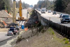 Keith Thorpe/Peninsula Daily News
Crains set at the site of the new U.S. 101 bridge over Siebert Creek between Port Angeles and Sequim after three out of six 175-foot-long concrete girders were hoisted into place on Tuesday. Traffic delays of up to 20 minutes at the site are possible today to accommodate heavy machinery used to place the remaning girders occupy the parallel bridge. The project was designed to replace an aging culvert that was a hinderance to fish passage in Siebert Creek with additional culvert removed underway at nearby Bagley Creek. Traffic has been reduced to a single lane in each direction at both construction sites.