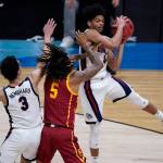 Gonzaga guard Aaron Cook, grabs a rebound over Southern California guard Isaiah White (5) during the first half of an Elite 8 game in the NCAA men's college basketball tournament at Lucas Oil Stadium, Tuesday, March 30, 2021, in Indianapolis. (AP Photo/Darron Cummings)