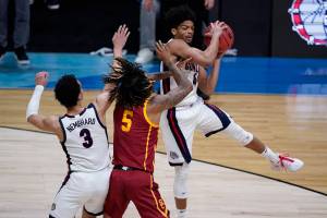 Gonzaga guard Aaron Cook, grabs a rebound over Southern California guard Isaiah White (5) during the first half of an Elite 8 game in the NCAA men's college basketball tournament at Lucas Oil Stadium, Tuesday, March 30, 2021, in Indianapolis. (AP Photo/Darron Cummings)