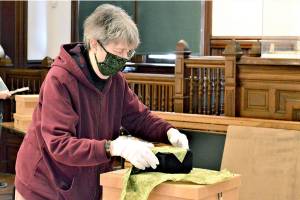Artist Peggy Smith-Venturi prepares to unveil Unwrapped, her new exhibition at the Jefferson Museum of Art & History. The downtown Port Townsend museum reopens Friday. (Diane Urbani de la Paz/Peninsula Daily News)