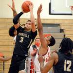 Peninsulas Jaylin Reed looks to get off a shot while heavily defended by Skagit Valley during the Pirates 71-68 OT loss to the Cardinals. (Rick Ross/Peninsula College)