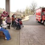Local law enforcement, first responders, and friends and family of Lorraine Hansen drove through waving and wishing her well Friday morning at the Port Townsend Life Care Center in honor of her 104th birthday on Saturday, April 3, 2021. (Zach Jablonski/Peninsula Daily News)