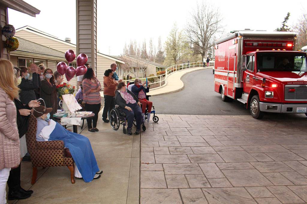 Local law enforcement, first responders, and friends and family of Lorraine Hansen drove through waving and wishing her well Friday morning at the Port Townsend Life Care Center in honor of her 104th birthday on Saturday, April 3, 2021. (Zach Jablonski/Peninsula Daily News)