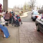 Local law enforcement, first responders, and friends and family of Lorraine Hansen drove through waving and wishing her well Friday morning at the Port Townsend Life Care Center in honor of her 104th birthday on Saturday, April 3, 2021. (Zach Jablonski/Peninsula Daily News)
