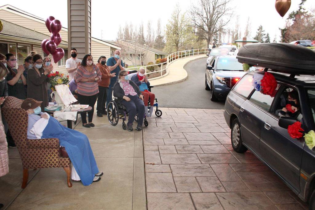 Local law enforcement, first responders, and friends and family of Lorraine Hansen drove through waving and wishing her well Friday morning at the Port Townsend Life Care Center in honor of her 104th birthday on Saturday, April 3, 2021. (Zach Jablonski/Peninsula Daily News)