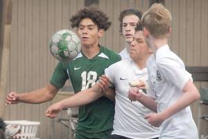Keith Thorpe/Peninsula Daily News
Port Angeles' Dayton Williams, left, chases a loose ball against Klahowya players, from left, Zachary Sullivan, Oscar Peterson and Colin Swenland on Saturday at Wally Sigmar Field in Port Angeles.