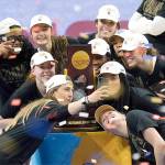Stanford players celebrate with the trophy after the championship game against Arizona in the women's Final Four NCAA college basketball tournament, Sunday, April 4, 2021, at the Alamodome in San Antonio. Stanford won 54-53. (AP Photo/Eric Gay)