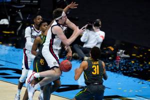 Gonzaga forward Drew Timme loses control of the ball in front of Baylor guard MaCio Teague (31) during the first half of the championship game in the men's Final Four NCAA college basketball tournament, Monday, April 5, 2021, at Lucas Oil Stadium in Indianapolis. (AP Photo/Michael Conroy)