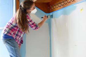 Jefferson Teen Center director Shayann Hoffer-Pauley helps turn one of the Chimacum centers walls sky blue on Monday afternoon. Shes working with the Rotary Club of Port Townsend to refresh the place over spring break. (Diane Urbani de la Paz/Peninsula Daily News)