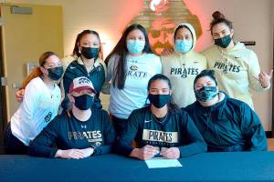 Photo courtesy of Peninsula College
Gina Brown, center, signs to play with the Peninsula College women's basketball court. At left is Peninsula women's coach Alison Crumb.