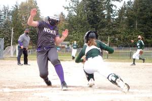 North Kitsap baserunner Kendall Becker scores past Port Angeles catcher Zoe Smithson. Smithson later hit a two-run home run. (Pierre LaBossiere/Peninsula Daily News)