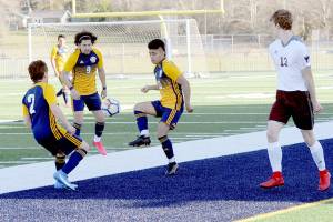 Spartans from left Juan Pablo Flores, Tony Flores-Hernandez and Andres Santos combine forces against Montesano on Tuesday at Spartan Stadium in Forks. (Lonnie Archibald/for Peninsula Daily News)
