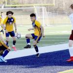 Spartans from left Juan Pablo Flores, Tony Flores-Hernandez and Andres Santos combine forces against Montesano on Tuesday at Spartan Stadium in Forks. (Lonnie Archibald/for Peninsula Daily News)