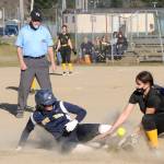 Forks Kyra Neel, left, slides safely into third base under the watchful eye of umpire Randy Rooney Tuesday afternoon in the second game of a doubleheader against North Beach at Tillicum Park in Forks. (Lonnie Archibald/for Peninsula Daily News)