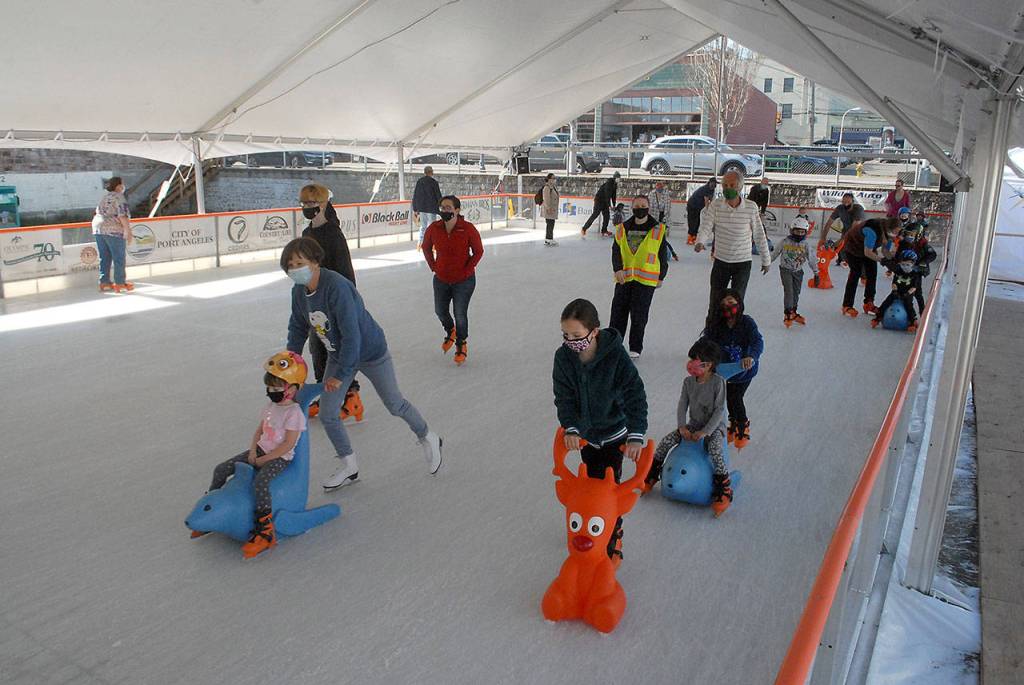 Skaters enjoy the ice on Satiurday at the Winter Ice Village. (Keith Thorpe/Peninsula Daily News)