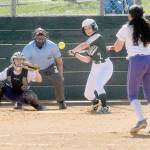 Port Angeles Peyton Rudd bats against Sequim pitcher Laina Vig as catcher Christy Grubb waits for the ball in the second inning on Saturday in Port Angeles. Rudd homered on the pitch. (Keith Thorpe/Peninsula Daily News)