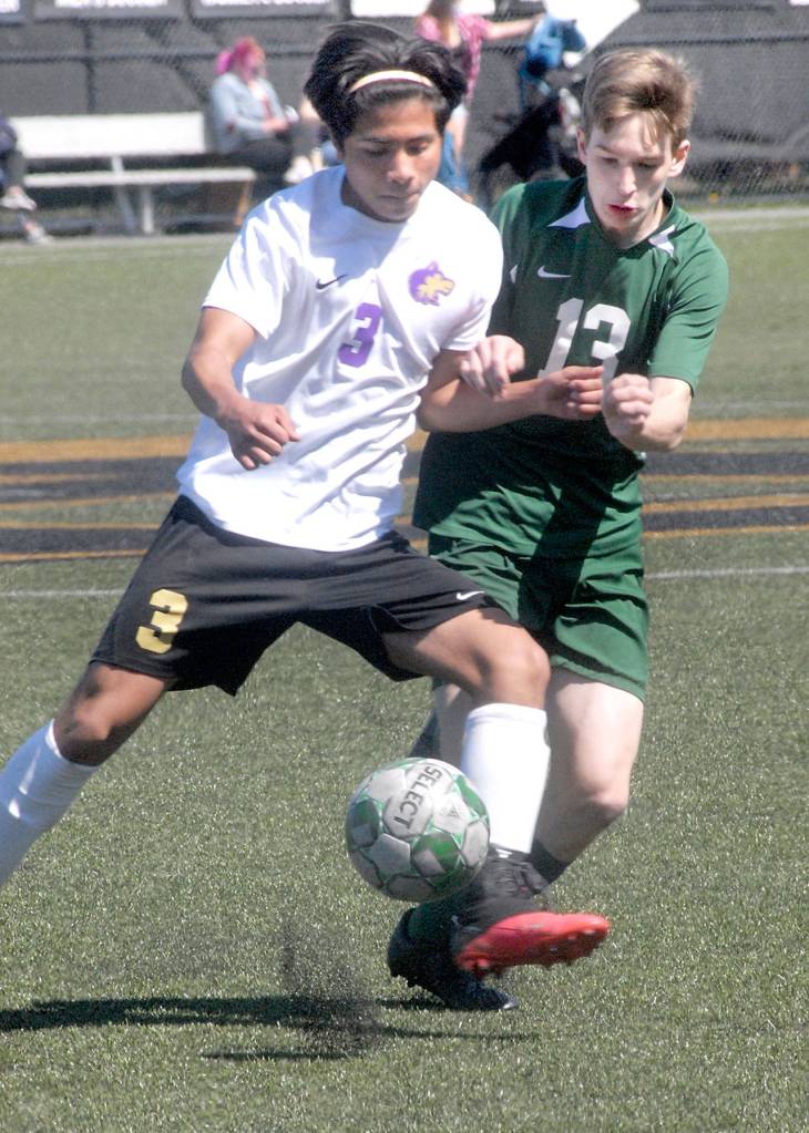 Keith Thorpe/Peninsula Daily News Sequims Christian Gonzales, left, and Port Angeles Josiah Long battle for the ball on Saturday in Port Angeles.