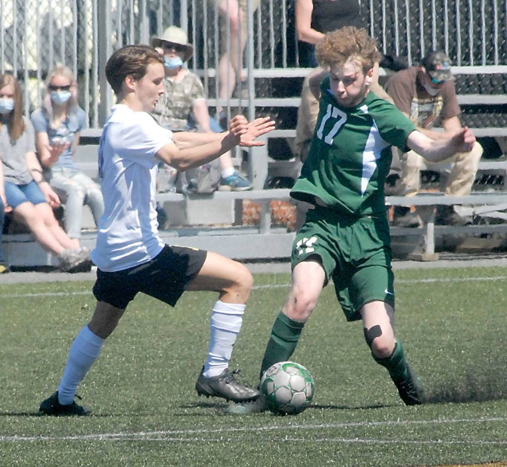 Keith Thorpe/Peninsula Daily News Sequims Ethan Anderson defends against Port Angeles Porter Litle during Saturdays match at Peninsula College.