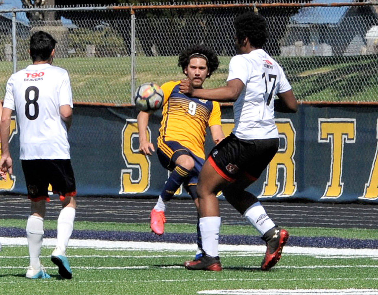 Forks Tony Flores-Hernandez (9) battles for a loose ball against Elma in Forks on Saturday. (Lonnie Archibald/for Peninsula Daily News)