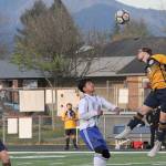 Lonnie Archibald/for Peninsula Daily News
Forks defender Colton Duncan heads the ball away during the Spartans win over Elma while Spartan Luis Torres (12) looks on.