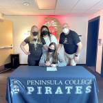 Port Angeles senior Myra Walker, seated, has signed a letter of intent to play basketball for Peninsula College. Walker is joined by from left, Peninsula head coach Alison Crumb and assistant coaches Gabi Fenumiai and Mike Knowles.