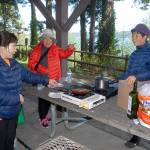 Keith Thorpe/Peninsula Daily News
Young Hanson of Dallas, left, along with Chun Kim and Jennifer Choi, both of Tacoma, prepares lunch at a picnic shelter at Sequim Bay State Park east of Sequim on Thursday. The group was taking advantage of a free day at all Washington state parks in celebration of Earth Day. The next free state parks day will be June 5 to celebrate National Trails Day.