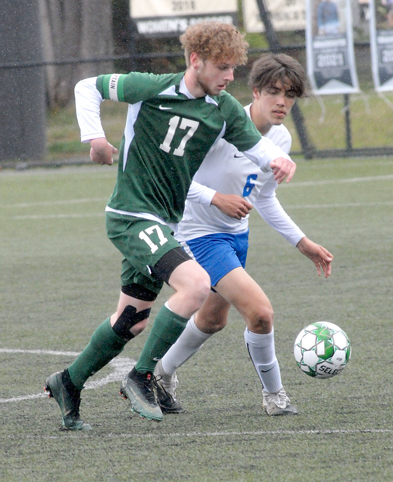 Port Angeles Porter Litle, front, races with Bremertons Jeffery Pickering for the ball on Saturday in Port Angeles. (Keith Thorpe/Peninsula Daily News)