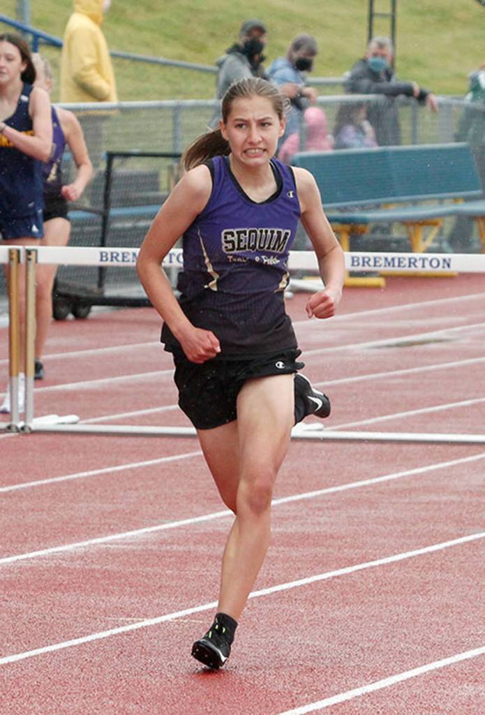 Taryn Johnson of Sequim on her way to second place in the 300-meter hurdles. (Mark Krulish/Kitsap News Group)