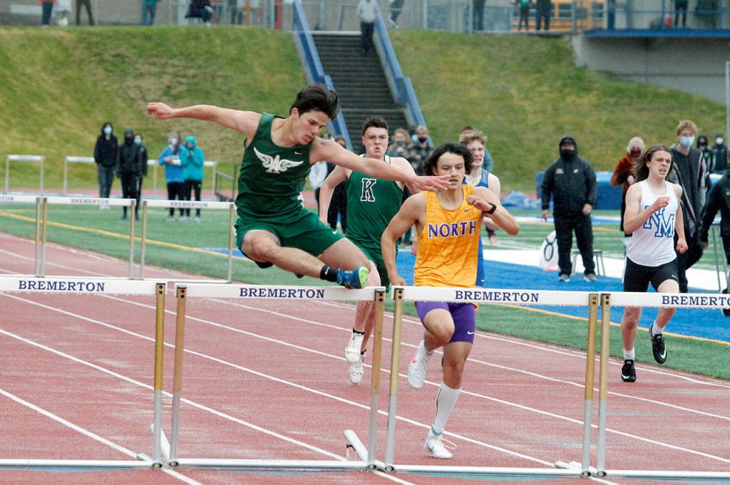 Xander Maestas of Port Angeles overtakes North Kitsaps Tenichi Gordon to win the 300-meter hurdles. (Mark Krulish/Kitsap News Group)