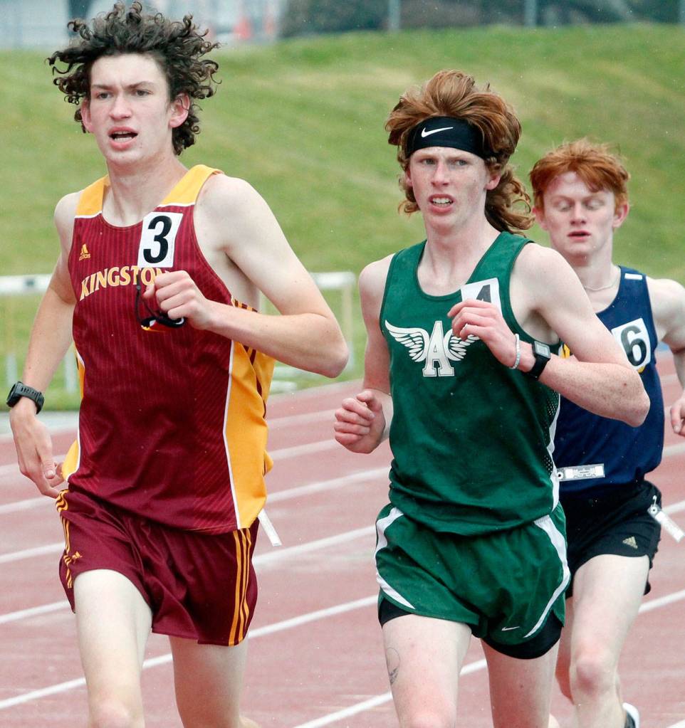 Jack Gladfelter of Port Angeles runs in the middle of the second pack between Kingstons Curtis Upton and Bainbridges Alex Miller in the 3200. (Mark Krulish/Kitsap News Group)