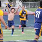 Forks' Juan Pablo Flores waves his jersey in celebration after scoring the first goal against Columbia Adventist during this playoff contest at Spartan Stadium in Forks Tuesday evening.  Also pictured are Andres Santos (13) Aristeo Ayala-Weed (18) and Luis Perez (21). (Lonnie Archibald/for the Peninsula Daily News)