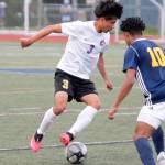 Mark Krulish/Kitsap News Group
Sequim's Christian Gonzales looks to dribble past Bainbridge's Damoni Mckenna-Greenawalt during the Olympic League Boys Soccer Championship.