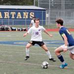 Sequims Eli Gish defends Bainbridges John Roman as he looks to pass upfield during the Olympic League Boys Soccer Championship Game. (Mark Krulish/Kitsap News Group)