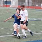 Sequims Ethan Anderson evades a tackle from Bainbridges Wyatt Friedman during the Olympic League Boys Soccer Championship. (Mark Krulish/Kitsap News Group)