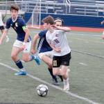 Sequims Ethan Knight squeaks by the Bainbridge defense during the Olympic League Boys Soccer Championship. (Mark Krulish/Kitsap News Group)