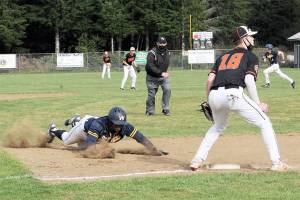Lonnie Archibald/for Peninsula Daily News
Forks' Trey Baysinger slides into third while in the background Riley Pursley heads for second during a successful double steal against Kalama. The Spartans edged the Chinooks 4-3 to advance to the district championship.
