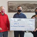 Gary Huff, left, board director and campaign chairman for the Olympic Peninsula YMCA’s 2021 Impact Campaign, accepts a donation for the YMCA from 1st Security Bank, represented by Vice President Branch Manager Anthony Aceto and 1st Security personal banker Sheena Zahn.(Photo courtesy of Olympic Peninsula YMCA)