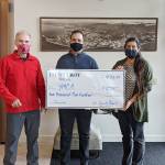 Gary Huff, left, board director and campaign chairman for the Olympic Peninsula YMCAs 2021 Impact Campaign, accepts a donation for the YMCA from 1st Security Bank, represented by Vice President Branch Manager Anthony Aceto and 1st Security personal banker Sheena Zahn. (Photo courtesy of Olympic Peninsula YMCA)